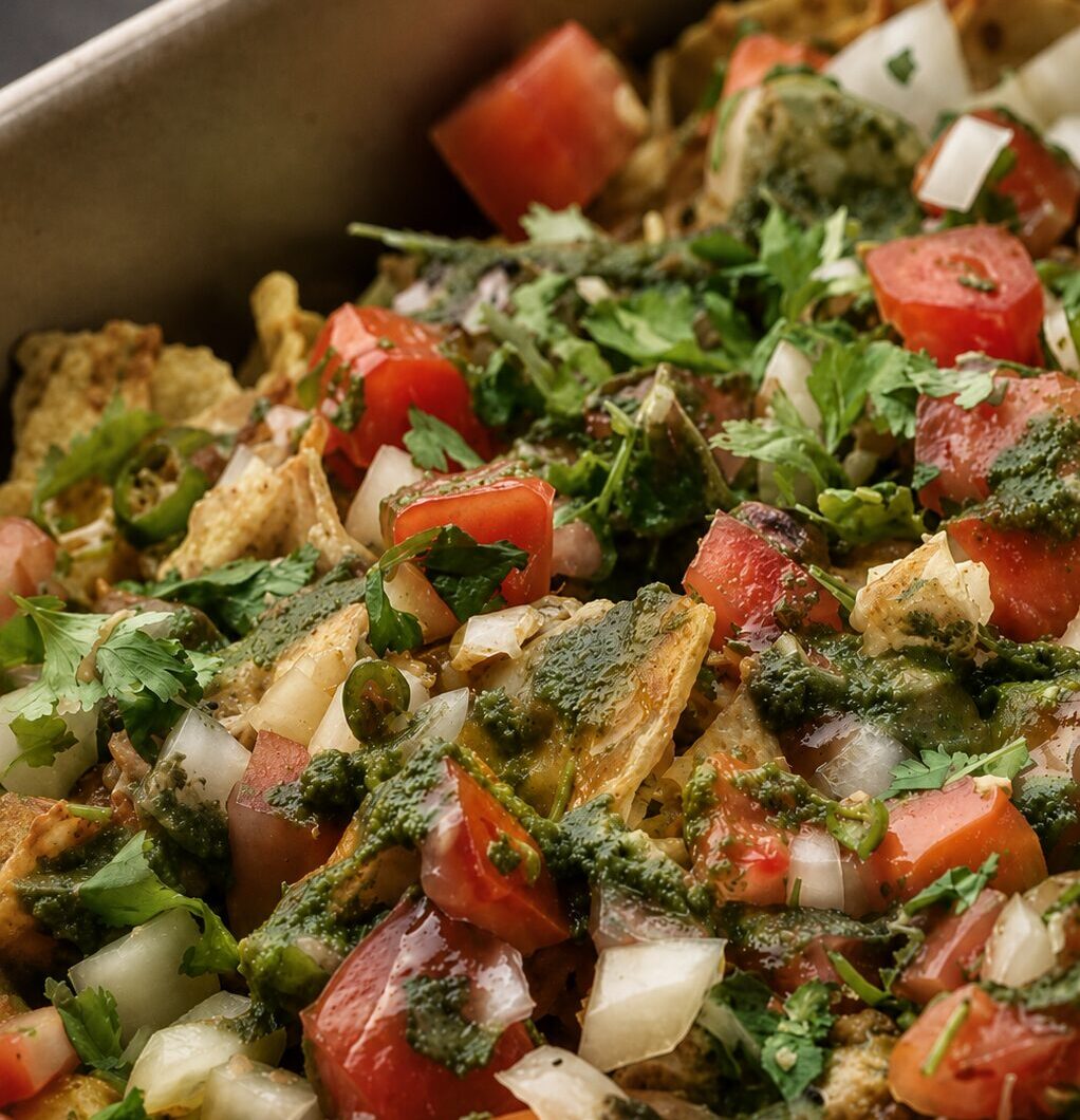 Fusion Nachos with chole, pico de gallo, mint chutney, and tamarind chutney
