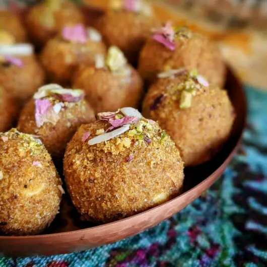 Besan Ladoo made with roasted gram flour, almonds, cardamom, and butter. This holiday dessert is sweet and delicious.