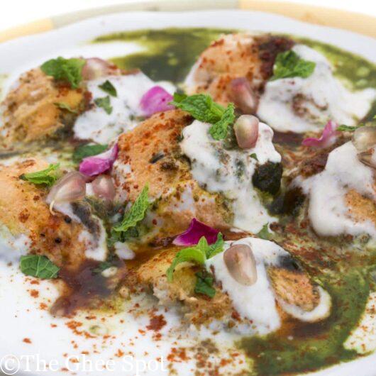 Delicious bready bhallas in creamy yogurt, garnished with spices and delicious chutneys.