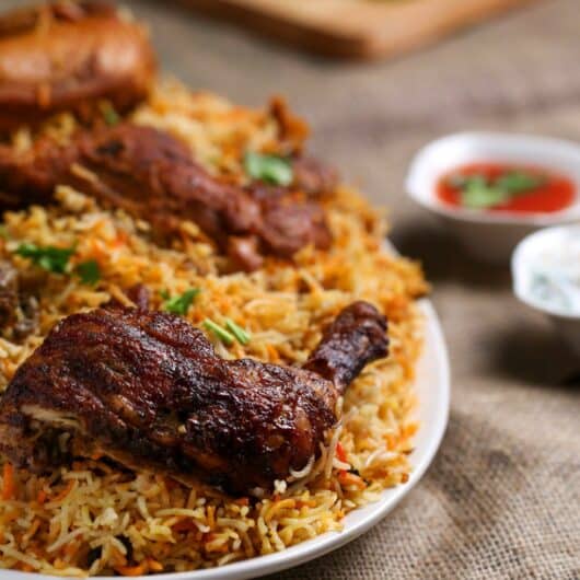 Savory marinated chicken layered with rice and then cooked together in an aromatic blend of spices