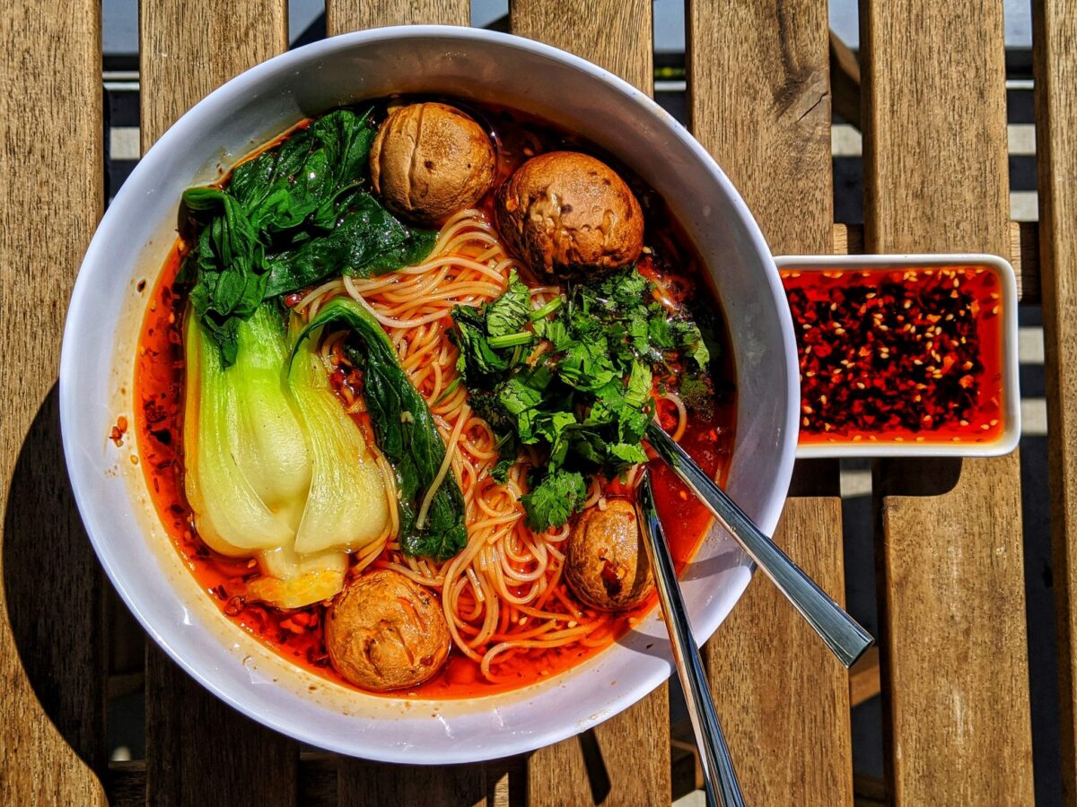 Spicy, savory, delicious Chongqing Noodles with bok choy, mushrooms, shrimp, chili oil, and noodles.