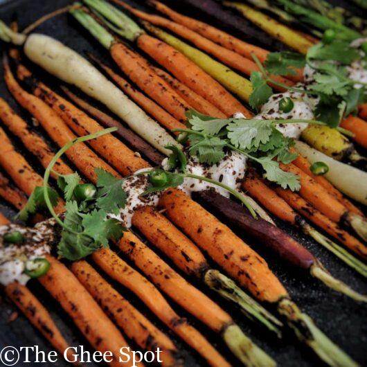 Savory grilled carrots with a cumin yogurt are perfect for an appetizer, snack, or side to a midweek or Thanksgiving dinner.