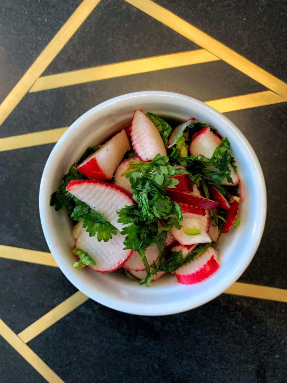 Spicy and tangy radish, lime, cilantro, and chili peppers make this delicious radish slaw.