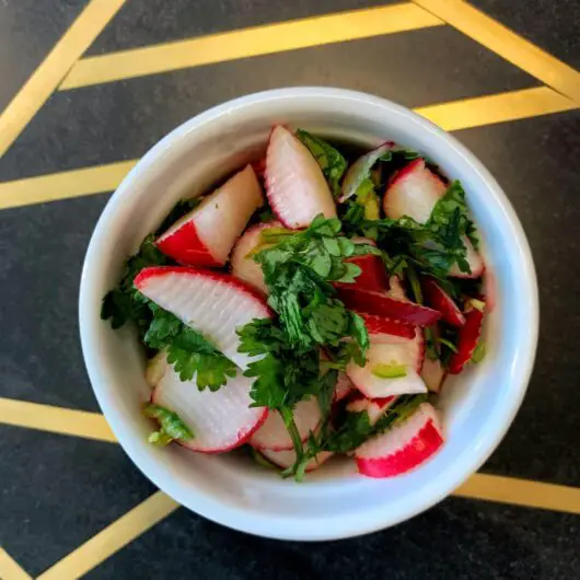 Spicy and tangy radish, lime, cilantro, and chili peppers make this delicious radish slaw.