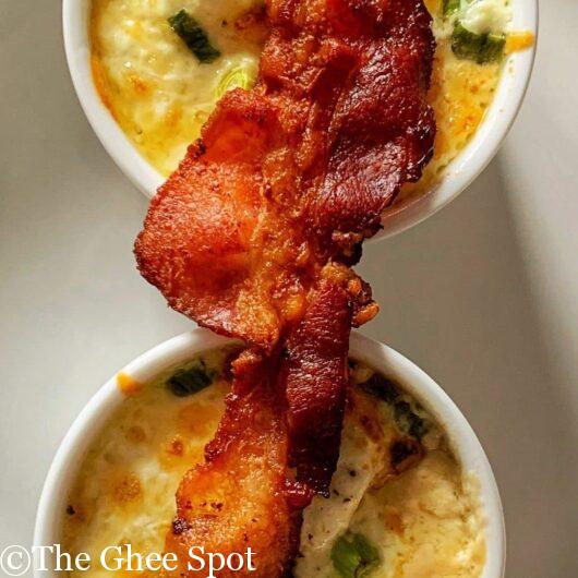 Baked eggs with bacon, mushroom, scallions, cheese, and heavy cream.