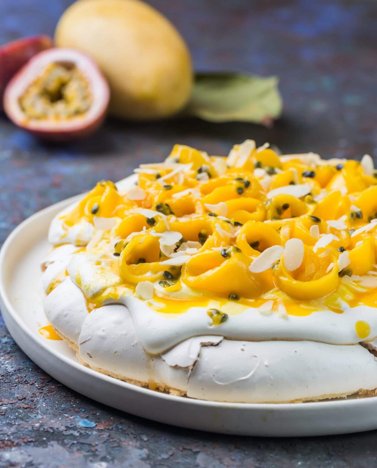 Rosewater pavlova with fresh cream, mango, and passionfruit syrup