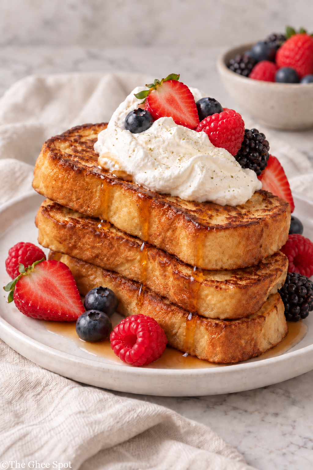 Thick brioche French toast topped with fresh chantilly cream and berries.