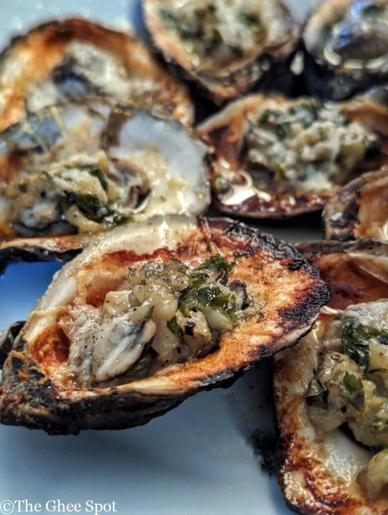 This recipe for grilled oysters with garlic butter and pecorino is perfect for any gathering.