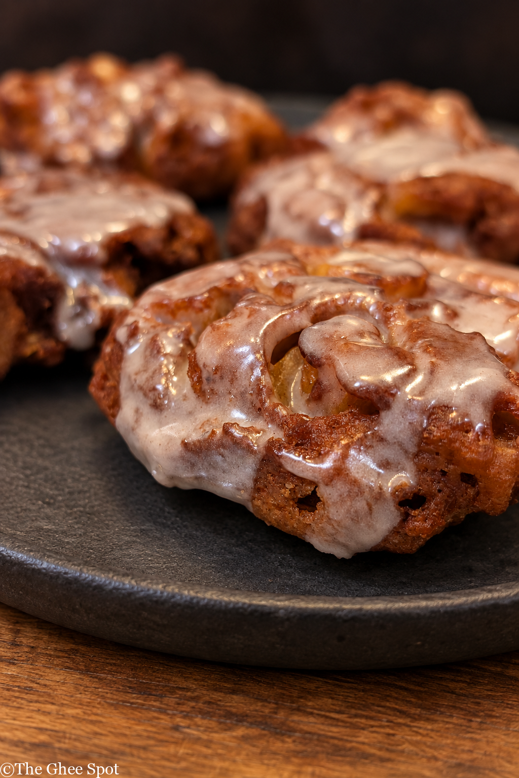 Pillowy soft fried apple fritter with cinnamon glaze.